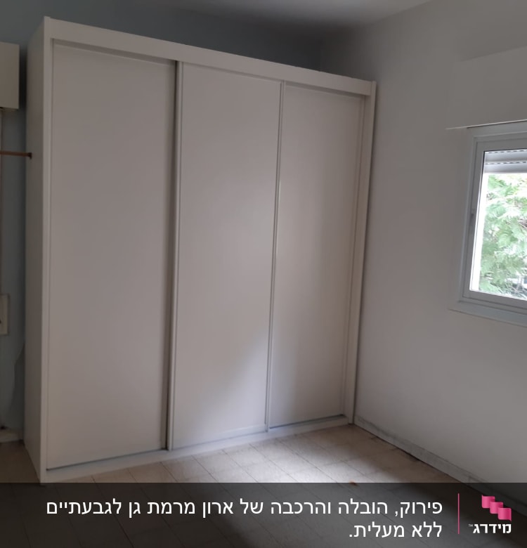 ארון לבן עם דלתות הזזה בחדר ריק